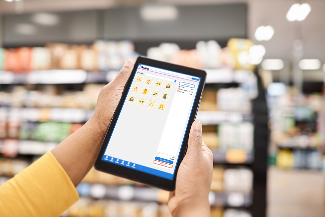 Supermarket manager using Kupa Retail on a tablet